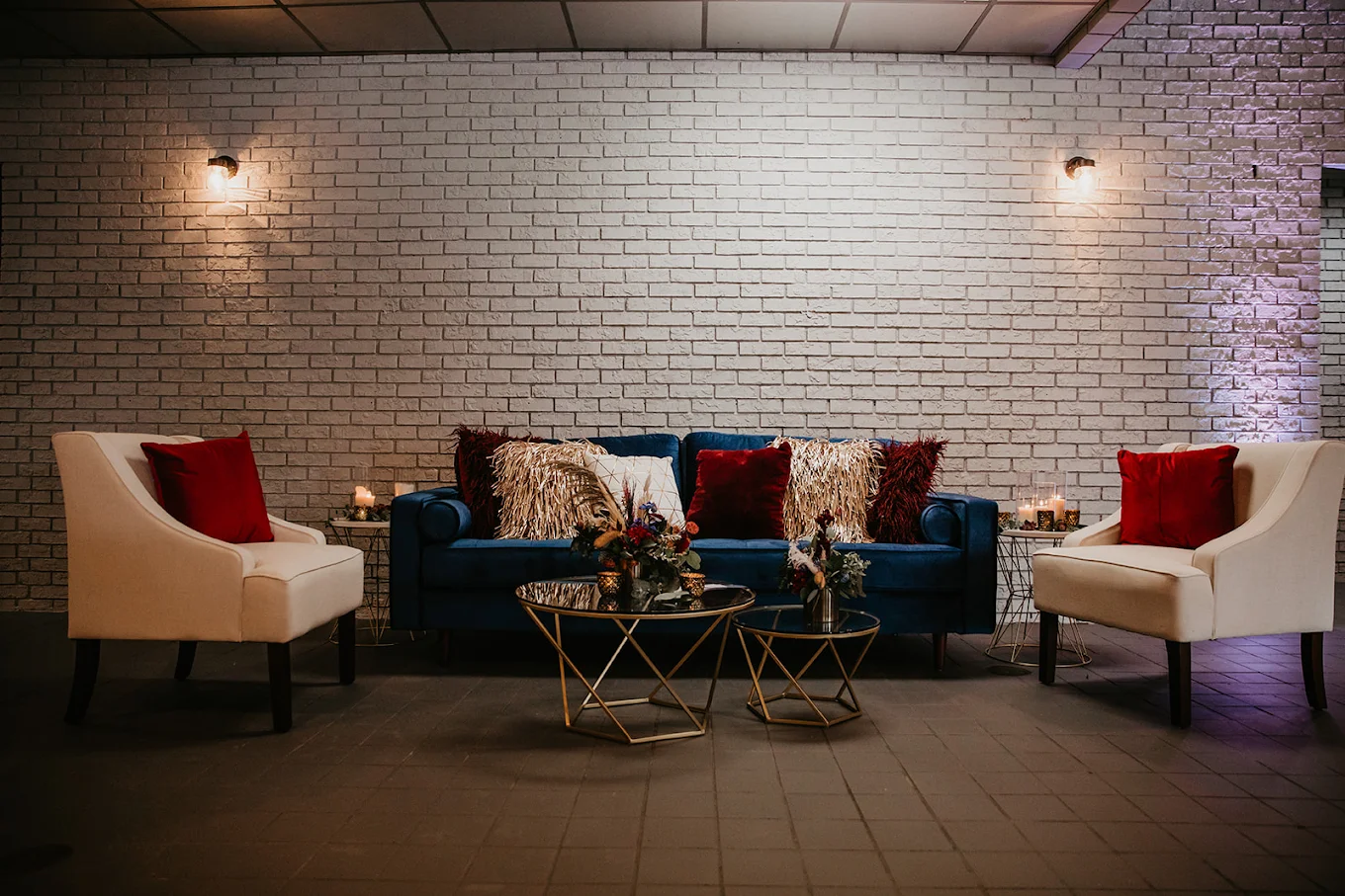 The lounge seating area at The Little Cottage with velvet sofas and accent lighting